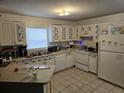 Functional kitchen featuring ample counter space, white appliances, and decorative floral accents at 1000 13Th S Ave, St Petersburg, FL 33705