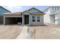 An unfinished single-story home featuring a two-car garage and visible building materials at 10648 Crescent Creek Xing, Parrish, FL 34219