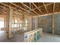 An unfinished interior of a house with exposed wooden framing and visible electrical wiring at 10648 Crescent Creek Xing, Parrish, FL 34219