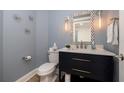 Stylish half-bathroom with a modern vanity, designer mirror, and elegant lighting at 11 Baymont St # 505, Clearwater Beach, FL 33767