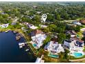 Stunning waterfront property with a private dock, pool, and lush landscaping at 11322 Carrollwood Dr, Tampa, FL 33618