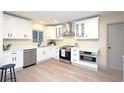 Bright kitchen featuring stainless steel appliances, modern white cabinets and quartz countertops at 11322 Carrollwood Dr, Tampa, FL 33618