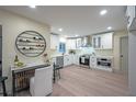 Modern kitchen with white cabinets, stainless steel appliances and a stylish wine rack feature at 11322 Carrollwood Dr, Tampa, FL 33618