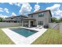Private pool with lounge chairs, a grill and a covered patio in the backyard of this lovely home at 12382 Tibbetts St, Odessa, FL 33556