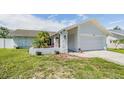 Charming home with a well-manicured lawn and ample parking space, complete with palm trees at 1304 Cedar Ct, Tarpon Springs, FL 34689