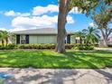 Lovely single-story home with beautiful landscaping, well-manicured lawn, and mature trees at 13186 Linden Place Dr, Seminole, FL 33776