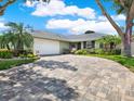 Inviting one-story home with a spacious brick driveway and well-maintained landscaping at 13186 Linden Place Dr, Seminole, FL 33776