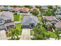 An aerial view showcases this home's backyard with white fencing and surrounding neighborhood at 14371 Edinburgh Moor Dr, Wimauma, FL 33598