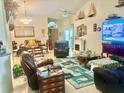 Cozy living room featuring comfortable seating, a fireplace, and a TV for relaxation at 1607 Alexander Crossing Way, Sun City Center, FL 33573