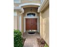 Inviting home entrance featuring a decorative transom window at 19743 Ellendale Dr, Land O Lakes, FL 34638