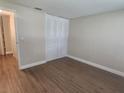 Bedroom with wood-look flooring, closet, and neutral walls at 209 Corkwood Ln Ln, Oldsmar, FL 34677