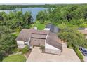Expansive aerial view showcasing the home's unique architecture and private lakeside setting at 2103 N Golfview Dr, Plant City, FL 33566