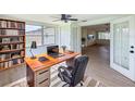 Cozy home office with built-in bookshelves, large window, and stylish desk, ideal for remote work at 2115 Erin Dr, Holiday, FL 34690