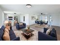 Open-concept living space with contemporary furnishings, hardwood floors, and ample natural light, perfect for entertaining at 2115 Erin Dr, Holiday, FL 34690