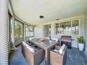 Covered patio with outdoor dining set and grill, perfect for enjoying meals al fresco at 2115 Erin Dr, Holiday, FL 34690