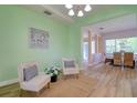 Inviting sitting room with light green walls leads into the dining room at 2228 Hannah S Way, Dunedin, FL 34698