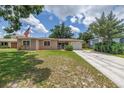Charming single-story home with a well-manicured lawn and an American flag at 2415 York N St, St Petersburg, FL 33710
