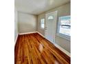 Sunlit living room featuring gleaming hardwood floors and neutral walls creating a warm and inviting atmosphere at 3110 10Th N Ave, St Petersburg, FL 33713