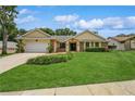 Charming single story home with a two car garage, manicured lawn, and beautiful landscaping at 3262 Westcott Ct, Palm Harbor, FL 34684