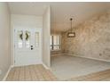 Bright foyer featuring tile flooring, neutral walls, and a decorative glass front door at 3262 Westcott Ct, Palm Harbor, FL 34684