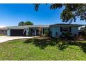 Charming one-story home with a two-car garage, manicured lawn, and lovely front yard landscaping at 3312 Kenmore Dr, Sarasota, FL 34231
