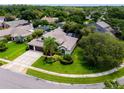 Expansive aerial view of a home with mature landscaping, a screened in lanai, and a two-car driveway at 335 Palmdale Dr, Oldsmar, FL 34677