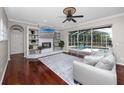 Relaxing living room with custom shelving around a brick fireplace, leading to the screened-in pool area at 335 Palmdale Dr, Oldsmar, FL 34677