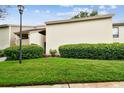 Well-manicured lawn and mature bushes enhance the appeal of this condo at 4114 Pinelake Ln # 202, Tampa, FL 33618