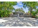 Charming home with a rustic wooden fence for privacy, mature trees, and gravel landscaping at 483 32Nd N Ave, St Petersburg, FL 33704