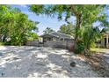 Charming home with a rustic wooden fence for privacy, mature trees, and gravel landscaping at 483 32Nd N Ave, St Petersburg, FL 33704