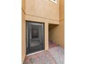 Covered townhome entrance with black screen door and brick paver walkway, creating an inviting welcome at 5030 Herring Ct, New Port Richey, FL 34652