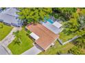 An aerial view shows the pool and a fenced yard, offering privacy and outdoor enjoyment at 5102 Peacock, Holiday, FL 34690