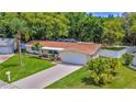 Beautiful single-story home with a lush, green lawn and mature landscaping at 5102 Peacock, Holiday, FL 34690