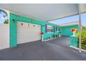 Attached carport featuring painted concrete, white garage door, and brick accents at 5107 Pine St, Seffner, FL 33584