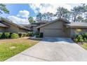Beautiful exterior view of the home showcasing the well-manicured lawn and attached two-car garage at 5340 Cobblestone Ct, Wesley Chapel, FL 33543