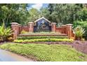 Entrance sign for Lake St. Charles, featuring brick pillars, lush landscaping, and a decorative community marker at 7101 Bucks Ford Dr, Riverview, FL 33578