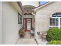 Welcoming front entrance with brick accents, decorative door, and landscaped garden enhancing curb appeal at 7101 Bucks Ford Dr, Riverview, FL 33578