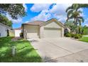 Spacious three-car garage with a wide concrete driveway, set in a well-maintained yard with mature trees at 7101 Bucks Ford Dr, Riverview, FL 33578