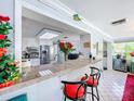 A kitchen with granite countertops and an open bar area with seating at 7111 Lawnview Ct, Tampa, FL 33615