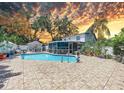 A sparkling blue pool is surrounded by an ample patio area with plenty of room for dining and lounging at 7111 Lawnview Ct, Tampa, FL 33615