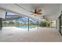Spacious screened-in lanai featuring a pool, ceiling fans, and clear views of the outdoors at 734 Flamingo Dr, Apollo Beach, FL 33572