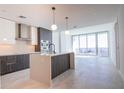 Modern kitchen with sleek cabinetry, island with breakfast bar, and large windows with city views at 777 3Rd N Ave # 1607, St Petersburg, FL 33701