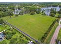 Wide aerial view of a large grassy lot, perfect for building your dream home or development opportunity at 820 Newberger Rd, Lutz, FL 33549