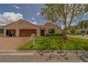 Villa with a well-manicured lawn, barrel tile roof, and mature landscaping at 8701 40Th N Ln, Pinellas Park, FL 33782