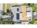 Aerial view of a home with solar panels, backyard, and a cozy firepit area at 9056 108Th Ave, Seminole, FL 33777