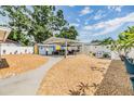 Spacious backyard with a covered patio, outdoor seating, and mature landscaping at 9056 108Th Ave, Seminole, FL 33777