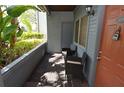 View of the unit's porch with two chairs and foliage view at 10265 Gandy N Blvd # 1409, St Petersburg, FL 33702