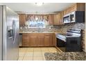 Well-lit kitchen featuring stainless steel appliances, granite countertops, and tiled backsplash at 10336 Alice M Ct, Port Richey, FL 34668