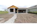 New construction of the home with block walls, garage space, and a stone walkway at 11858 Richmond Trl, Parrish, FL 34219