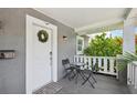 Inviting front porch with seating, a wreath, and a view of the charming neighborhood at 120 W Sligh Ave, Tampa, FL 33604